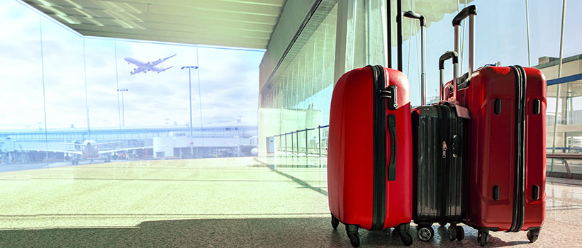 red suitcases outside airport