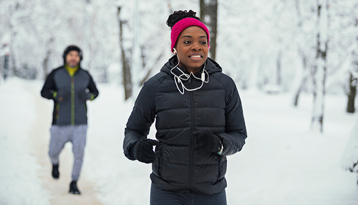 african american woman running outside in the winter