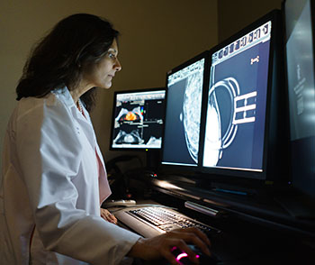Dr. Mehta examines a patient's mammogram