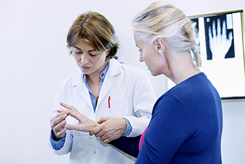 Rheumatologist Examining Joints of Patient's Hand