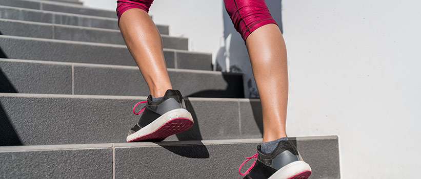 woman's legs seen running up outdoor stairs