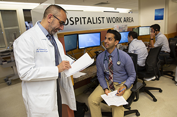 Chief Medical Officer Tony Weiss, MD, discusses patient care with a BIDMC resident. 