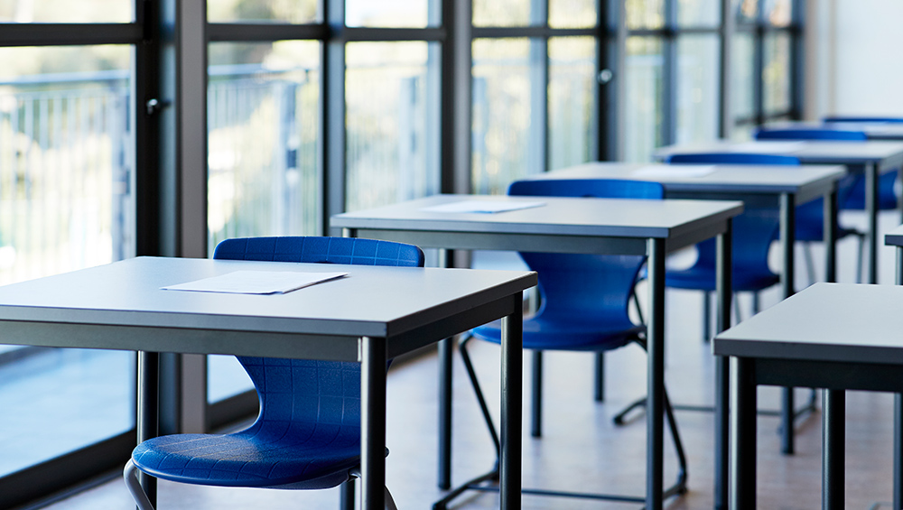 Empty classroom with desks and chairs