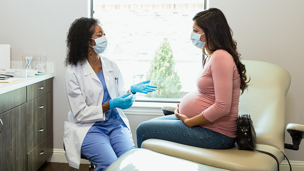 Pregnant woman with OB/GYN during medical appointment