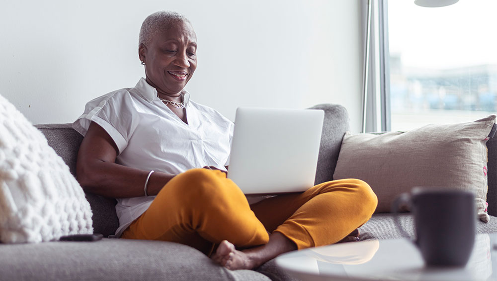 Woman using laptop on couch