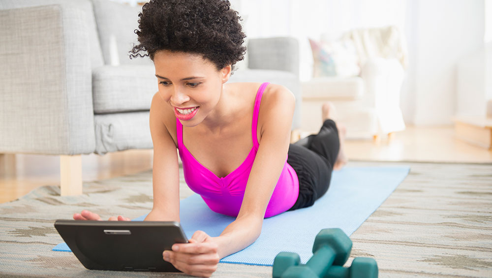 Woman combatting COVID-19 related stress with at-home exercise.