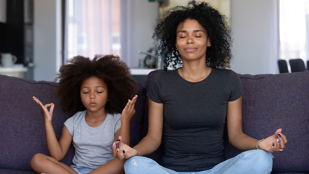 Mother and Daughter Meditating at Home