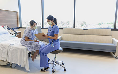 Female doctor with female patient Female doctor with female patient