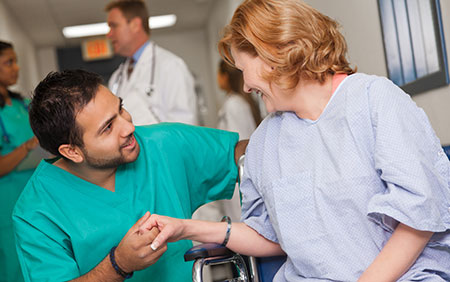 Nurse holding patient's hand
