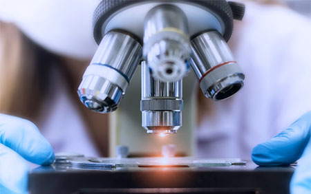 someone using a microscope