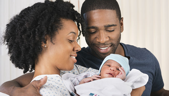 A mother and father with their newborn baby