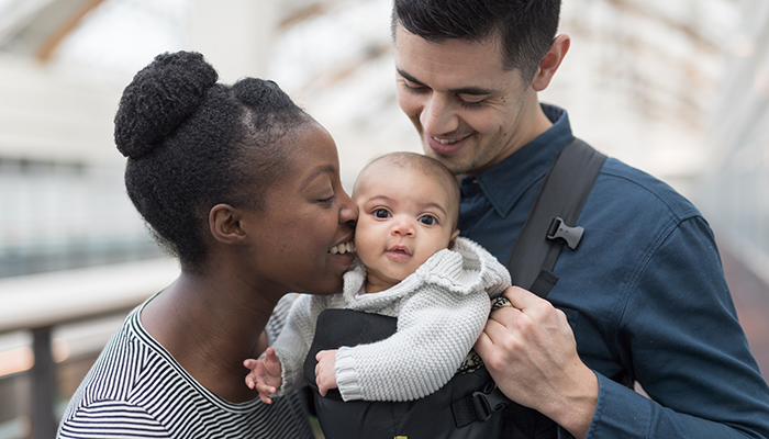 Adoring parents traveling with their baby