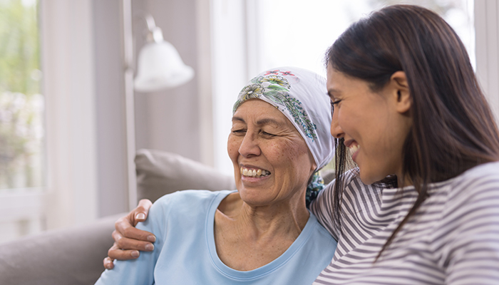 Cancer patient and daughter laugh together