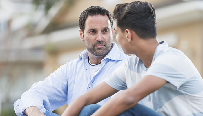 Father discusses cancer diagnosis with his son.