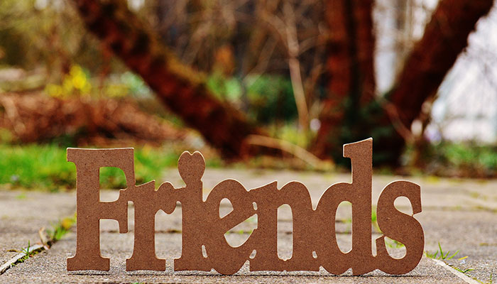 Friends Sign Outdoors