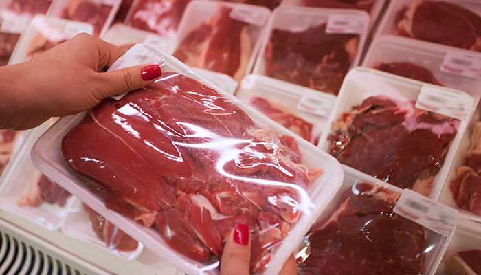 Woman Buying Red Meat at Grocery Store