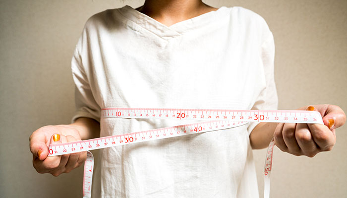 Mastectomy Choices - Breast Reconstruction vs. Going Flat Woman Measuring Chest