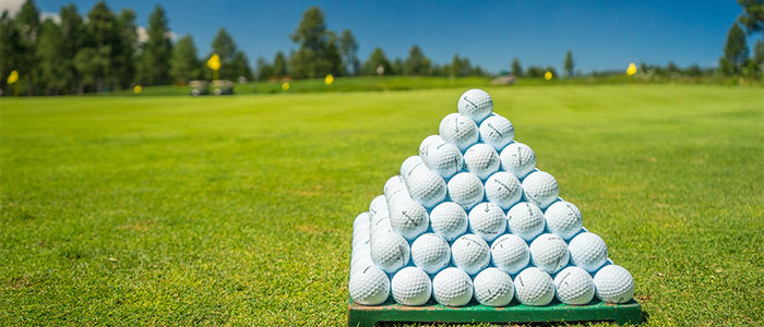 Pyramid of golf balls on a golf course Pyramid of golf balls on a golf course
