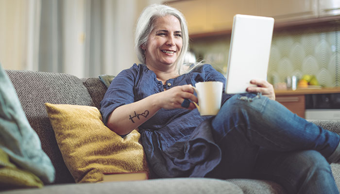 Woman attends virtual class on tablet