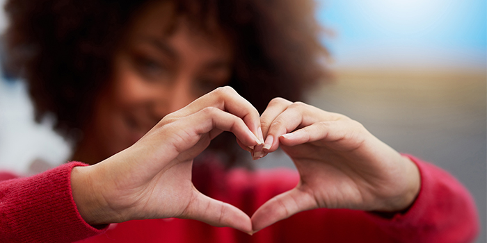 Woman making heart hands