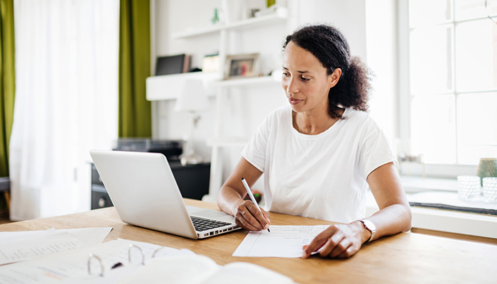 Woman watches a webinar on her laptop