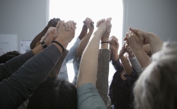 People holding hands in a circle.