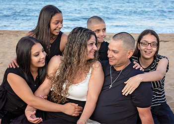 Edwin Rivera with his family on the beach