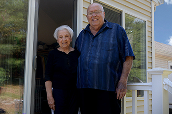 Louise and Jim Rand standing on their back porch