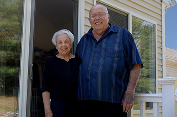 Louise and Jim Rand standing on their back porch