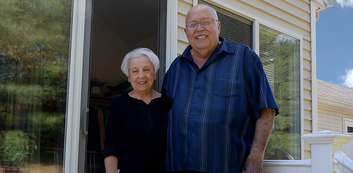 Louise and Jim Rand standing on their back porch