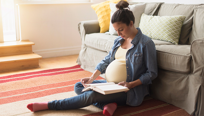 Are you pregnant and worried about COVID-19? Pregnant Woman Reading Book