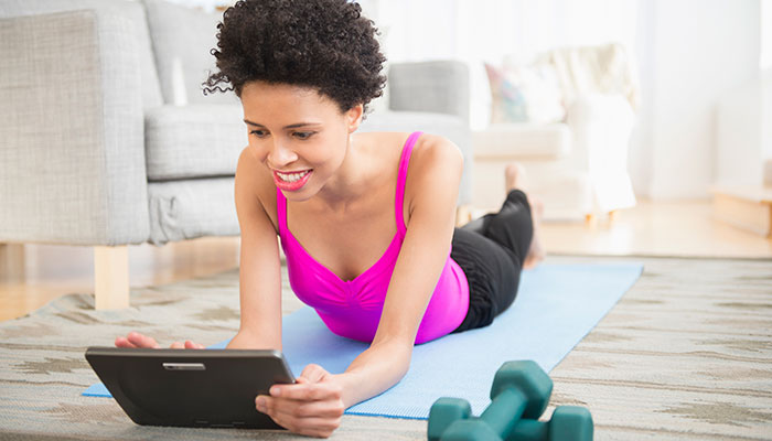 Woman combatting COVID-19 related stress with at-home exercise.