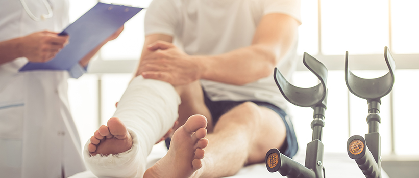 A doctor and patient talk about a leg injury