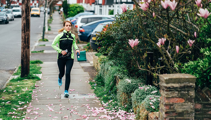 Female runner training in her neighborhood