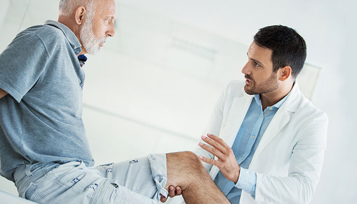 A doctor holding a patient's knee