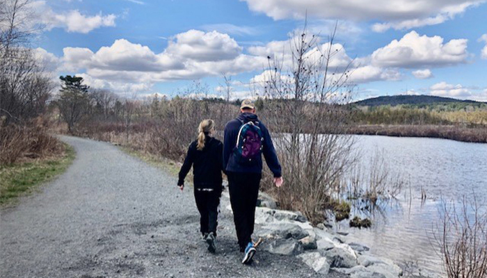 Kim Langway and Mary walking next to a pond