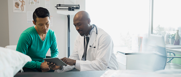 Doctor consulting with male patient