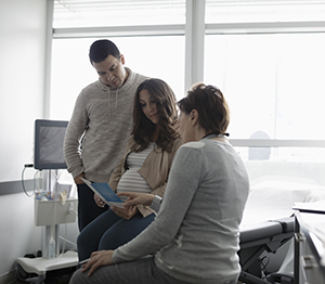 A couple is going over their pregnancy with a maternal-fetal medicine specialist