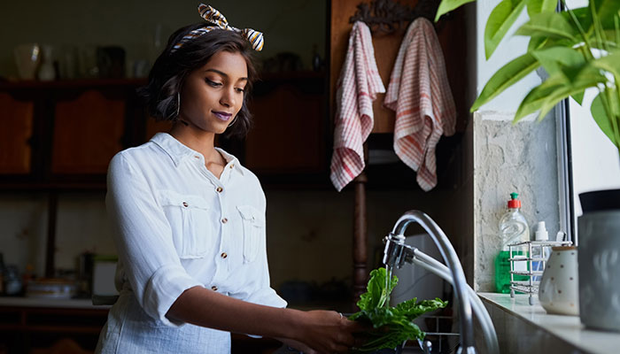 Pregnant Woman Washing Vegetables