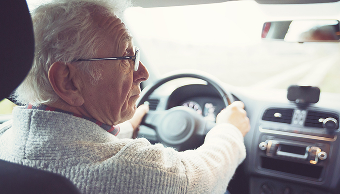 Senior adult male driving a car