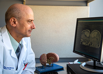 BIDMC Brain Tumor Center doctor reviews imagery of a brain