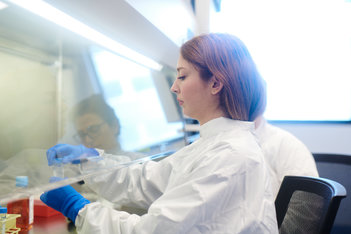 Tech and hood in lab