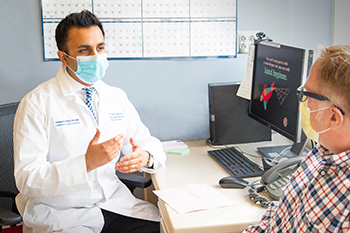 Dr. Usman Tahir talking to a patient Dr. Usman Tahir talking to a patient