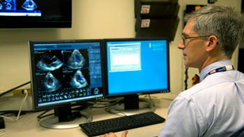 Dr. Warren Manning reads echocardiogram results on a computer