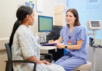 Dermatologist at BIDMC consulting a patient