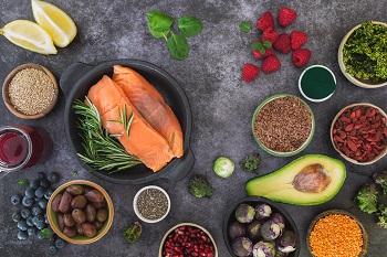 Salmon, fruits, vegetables, and grains on a table