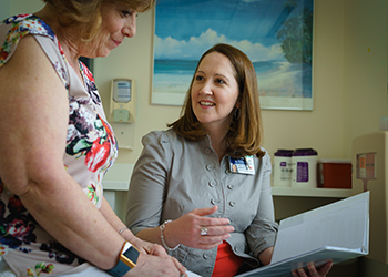 Colleen Baker, RN, BSN, speaks with a patient Colleen Baker, RN, BSN, speaks with a patient
