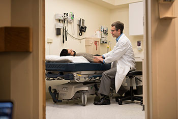 BIDMC’s Dr. Adam Cheifetz examines an IBD patient