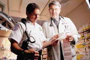 Physician reviewing paperwork with Medic