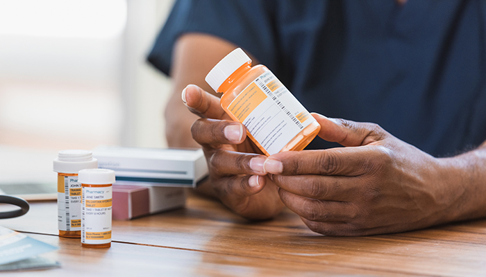 Hands holding medication bottle